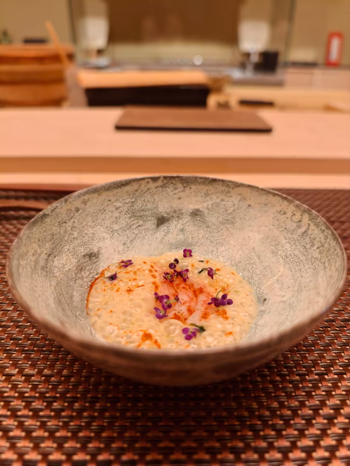 Chawanmushi with prawn and edible flowers in a glazed bowl