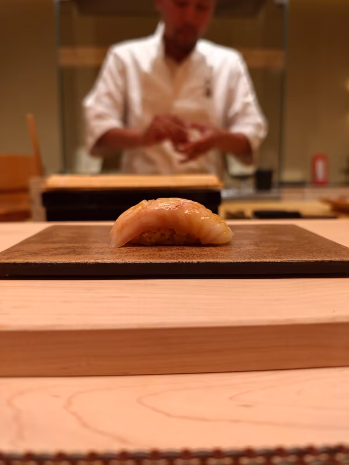 Nigiri placed on a ceramic plate at the counter