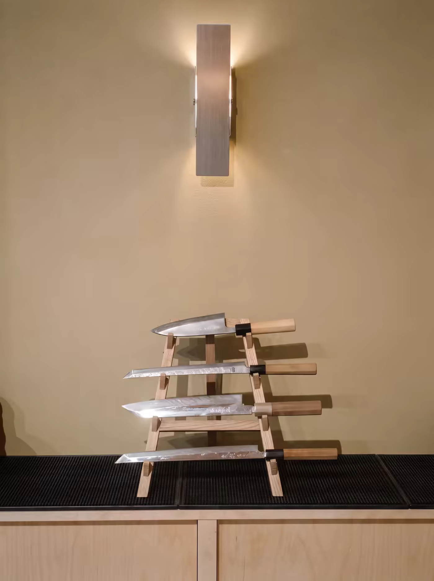 Japanese knives resting on a wooden stand